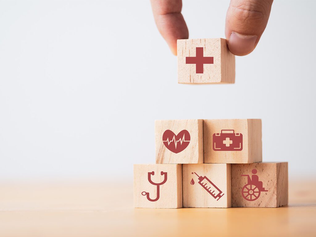 Stack of wooden blocks with health symbols