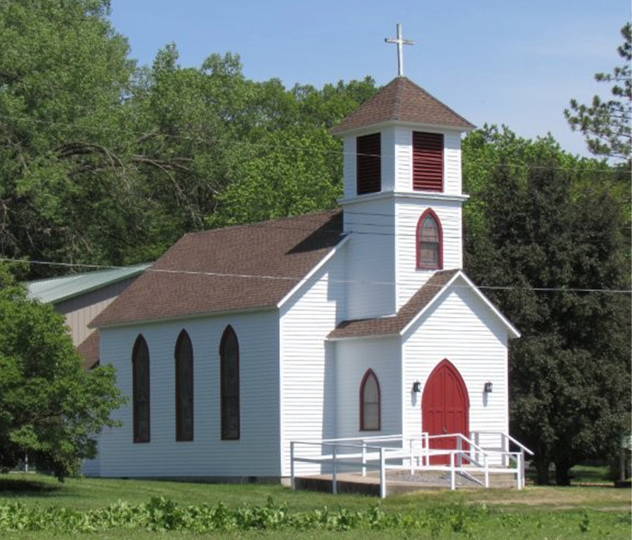 White church with stained glass windows and red door